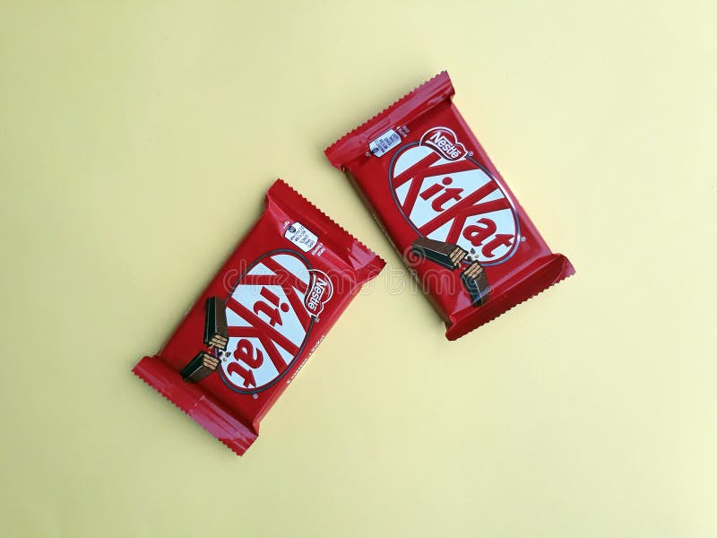 KHARKIV, UKRAINE - JANUARY 2, 2021 Kit Kat by Nestle chocolate covered wafer on bright color background. KHARKIV, UKRAINE - JANUARY 2, 2021 Kit Kat by Nestle chocolate covered wafer on bright color background