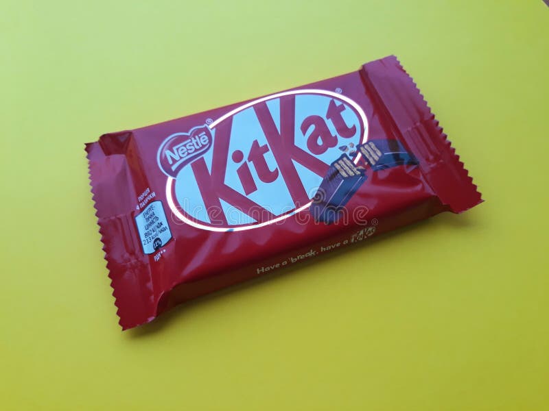 KHARKIV, UKRAINE - JANUARY 2, 2021 Kit Kat by Nestle chocolate covered wafer on bright color background. KHARKIV, UKRAINE - JANUARY 2, 2021 Kit Kat by Nestle chocolate covered wafer on bright color background