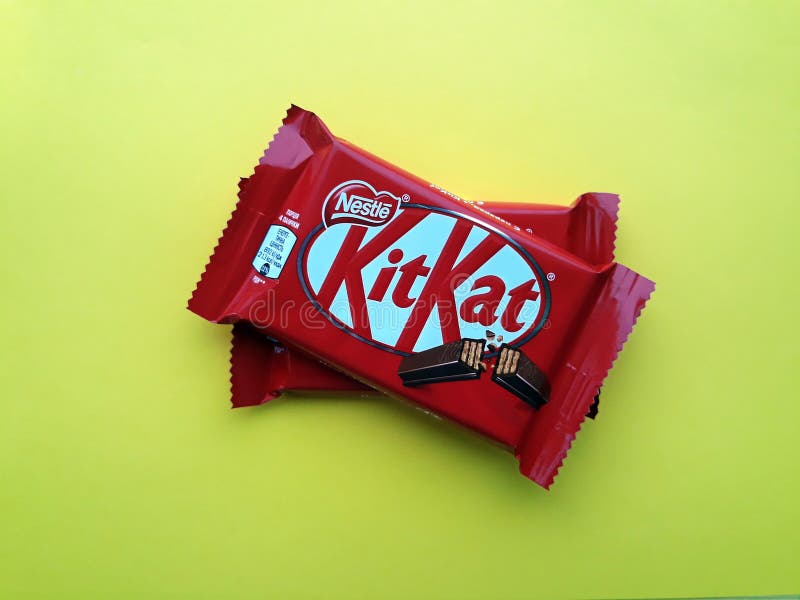 KHARKIV, UKRAINE - JANUARY 2, 2021 Kit Kat by Nestle chocolate covered wafer on bright color background. KHARKIV, UKRAINE - JANUARY 2, 2021 Kit Kat by Nestle chocolate covered wafer on bright color background