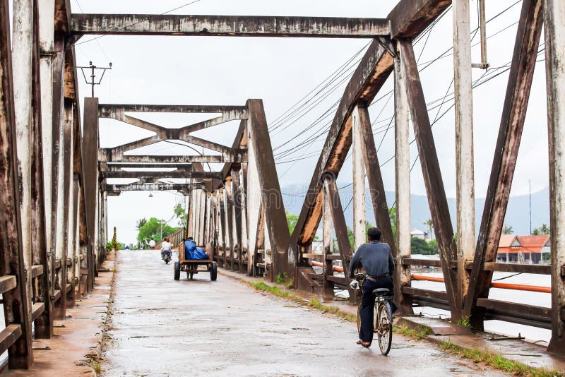 Khmer people cycling bicycles across the ancient bridge stock photos Khmer people cycling bicycles across the ancient bridge stock photos