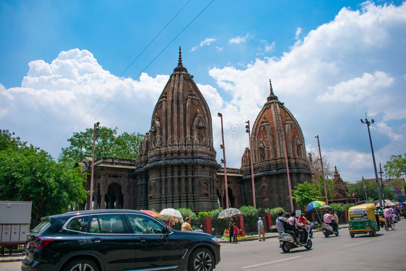 Khrishanpura or Kishanpura Chatri or Cenotaphs or Holkar Rulers Family of Indore with Blue Sky and Clouds in the Background, Vehicles and Street Vendors are also visible. These Cenotaphs are the samadhis of Krishna Bai Holkar and Tukoji Rao Holkar. Khrishanpura or Kishanpura Chatri or Cenotaphs or Holkar Rulers Family of Indore with Blue Sky and Clouds in the Background, Vehicles and Street Vendors are also visible. These Cenotaphs are the samadhis of Krishna Bai Holkar and Tukoji Rao Holkar