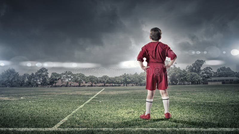 Kid boy on soccer field