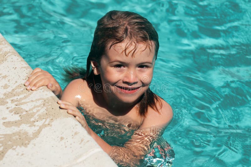 Kid Boy Swim in Swimming Pool. Boy Practice Swimming. Stock Photo