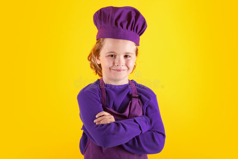 Kid Chef Cook, Studio Portrait. Children Cooking. Kid Boy with Apron and Chef Hat. Stock Image