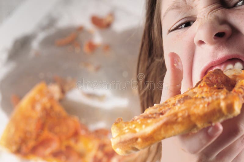 Kid devouring pizza stock photo Kid devouring pizza stock photo