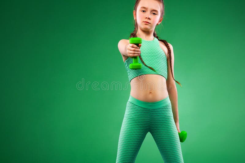 Kid Girl Doing Fitness Exercises with Dumbbells on Green Background ...