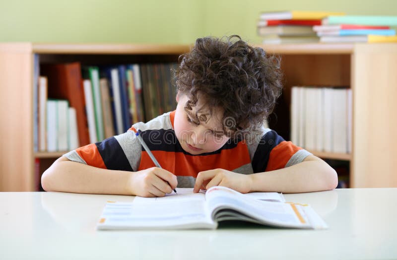 kid doing homework stock photo