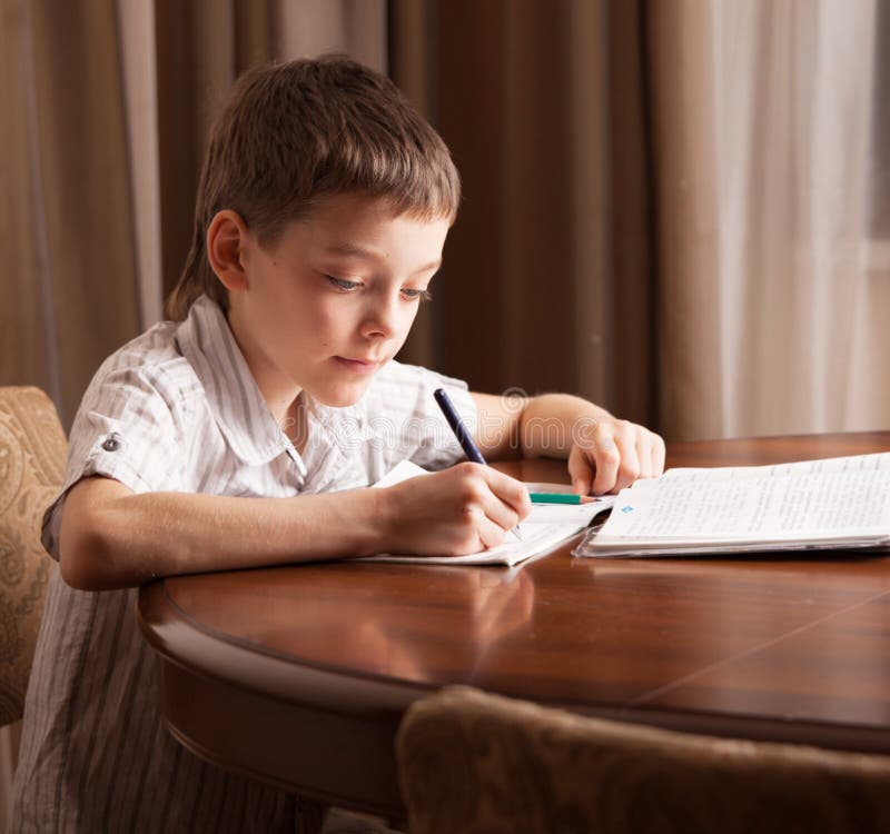 kid doing homework stock photo