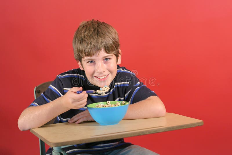 Kid eating cereal at desk