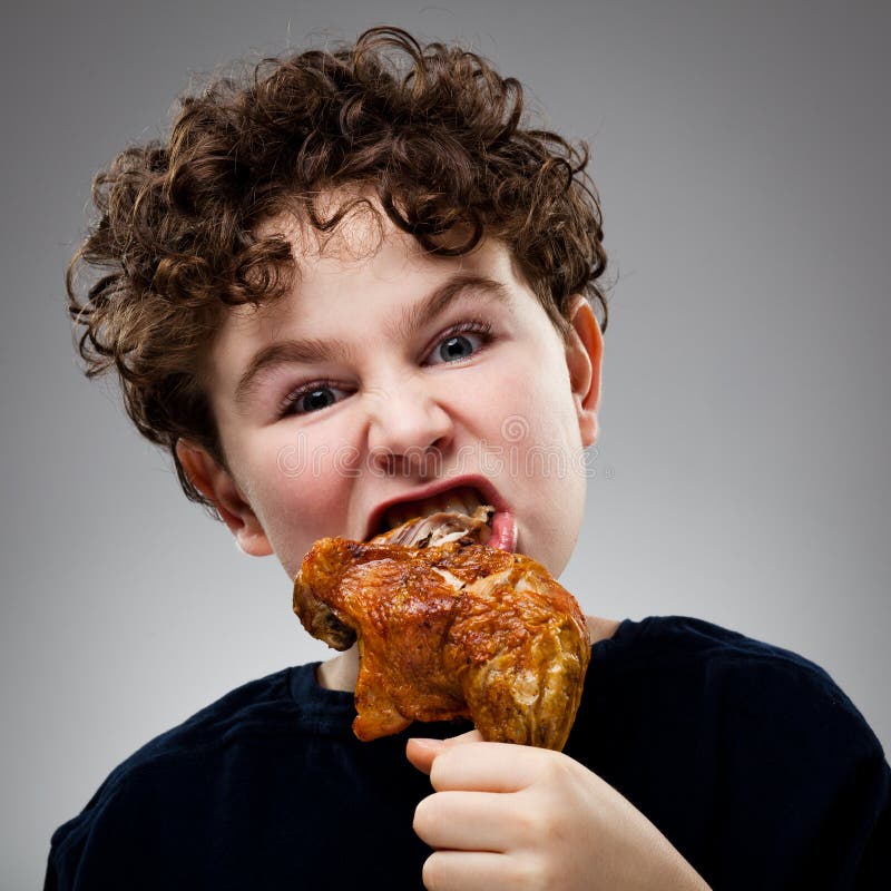 Kid eating chicken leg royalty free stock photography Kid eating chicken leg royalty free stock photography