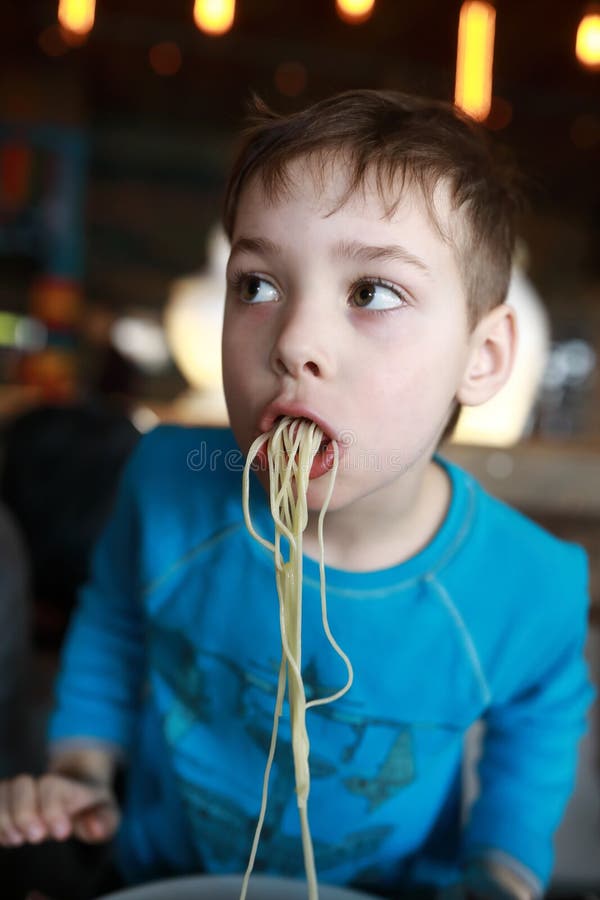 Kid eating spaghetti stock image. Image of cute, appetizer 144752851