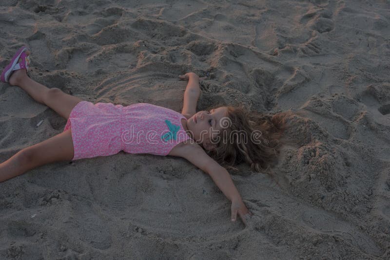 Kid girl on the beach stock image. Image of resting, shore 97218763