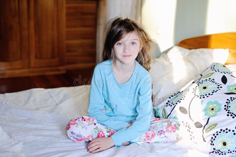 Kid girl on bed in the bedroom