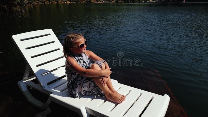 Kid Girl Lie on a Sunbed in Sunglasses and a Boho Silk Shawl. Child ...