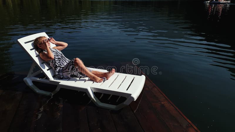 Kid Girl Lie on a Sunbed in Sunglasses and a Boho Silk Shawl. Child ...