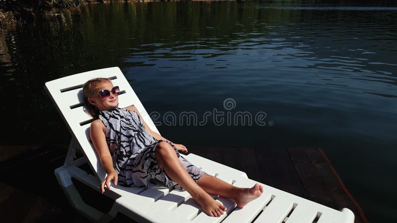 Kid Girl Lie on a Sunbed in Sunglasses and a Boho Silk Shawl. Child ...