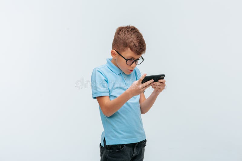 Kid with Glasses Who Plays Games on the Stock Photo Image