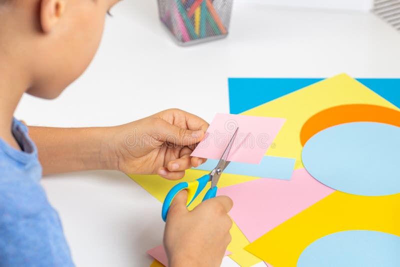 Kid Hands Cutting Colored Paper with Scissors. Education, Learning ...