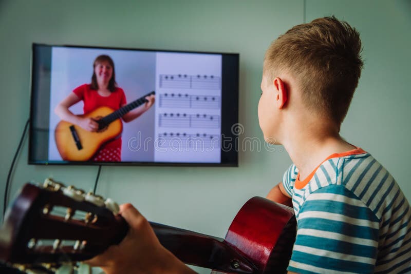 Kid having guitar lesson online, distant learning