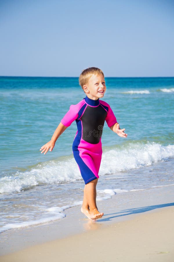 Kid in His Diving Suit Leaving Water at the Beach Stock Image Image