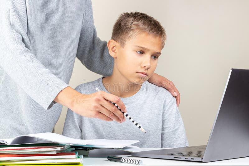 Kid learning online with laptop computer at home. Mother help him, explains task. Technology, remote education, distance. Learning, home studying stock images Kid learning online with laptop computer at home. Mother help him, explains task. Technology, remote education, distance. Learning, home studying stock images