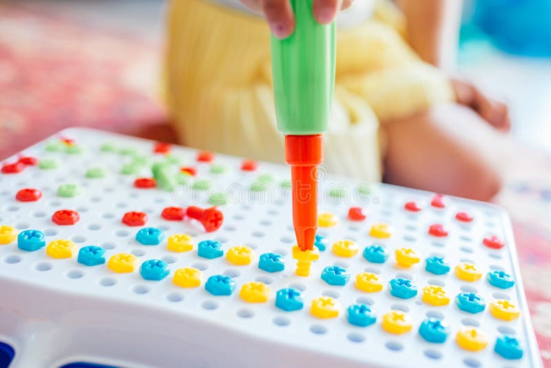 Kid learning to use screwdriver. Multicolor screws. Future occupation concept royalty free stock photo Kid learning to use screwdriver. Multicolor screws. Future occupation concept royalty free stock photo