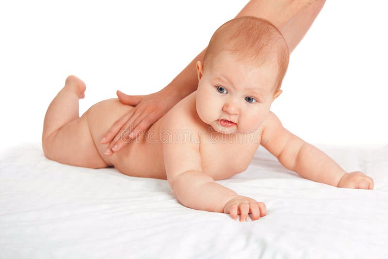 The kid loves a back massage. masseuse doing massage to the baby. stock photography The kid loves a back massage. masseuse doing massage to the baby. stock photography