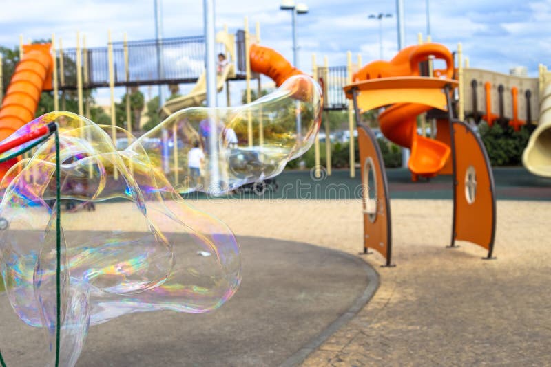 A Kid Makes Big Soap Bubbles in a Playground in Tel Aviv Stock Photo