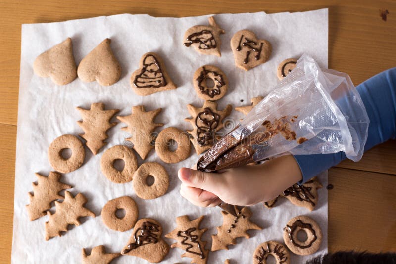 Kid making decoration on gingerbread cookie close up. Baking wit. Celebration, biscuit.