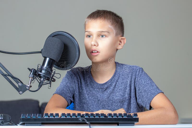 Kid Near Computer Talking into Microphone. Techology, Online Learning