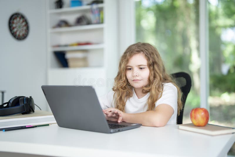 Kid on online lesson in home school. Child learning knowledge through homeschooling and online classes. Young student focused on royalty free stock images