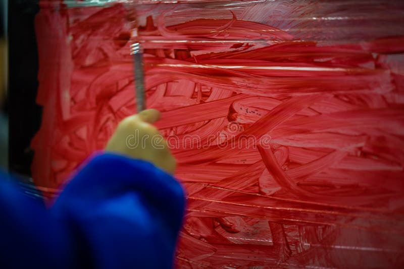 Kid is Painting the Plastic Wall with Red Color. Stock Image Image of colorful, happy 123631889
