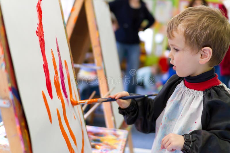 Kid painting at preschool stock photo Kid painting at preschool stock photo