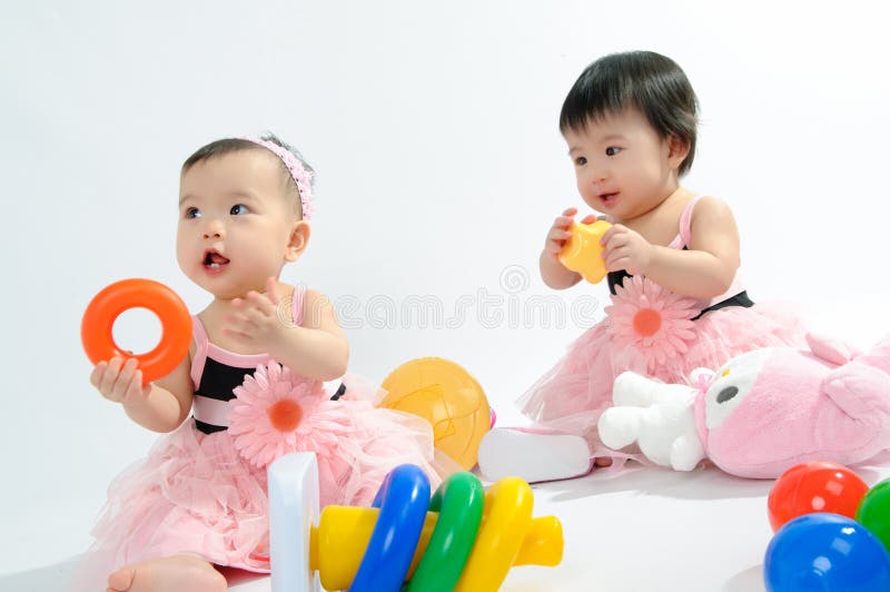 Kid in pink dress playing toy