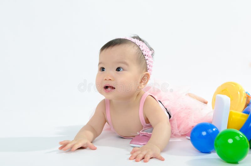 Kid in pink dress playing toy