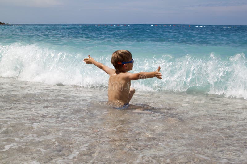 kid play with splahes waves of the sea royalty free stock photo kid play with splahes waves of the sea royalty free stock photo