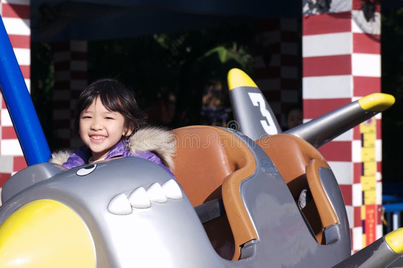 Asian little kid playing in the amusement park