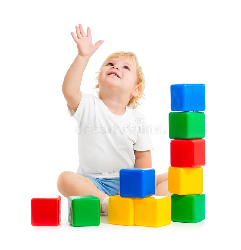 Kid playing with colorful building blocks and looking up stock photo