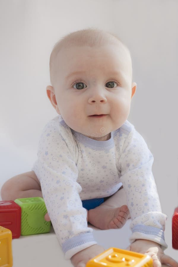 The kid plays with cubes