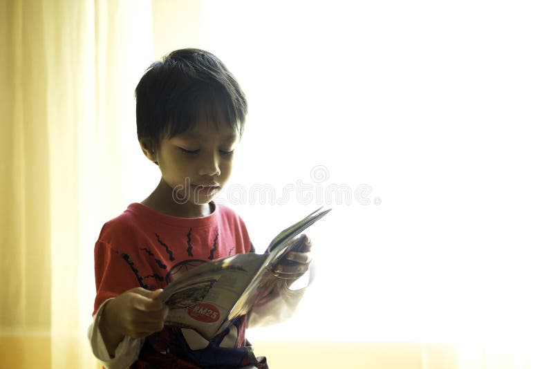 A Kid Reading a Book Near the Windows Editorial Stock Image Image of