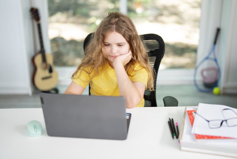 Kid studying mathematics on laptop during e-learning session. Student streaming lesson on modern technology. Child doing stock photos