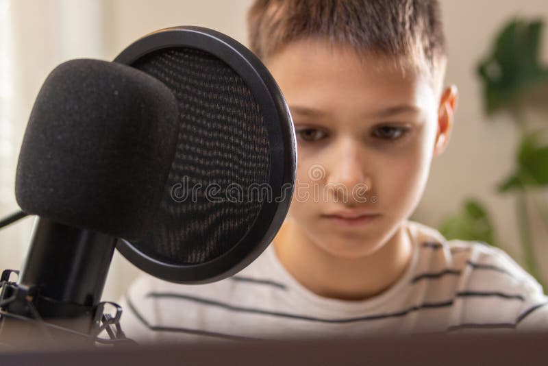 Kid Talking into Microphone. Techology, Online Learning, Remote