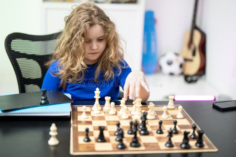 Kid thinking during chess game. stock photography