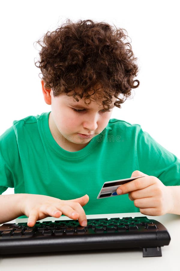Kid using credit card shopping on-line stock photo Kid using credit card shopping on-line stock photo