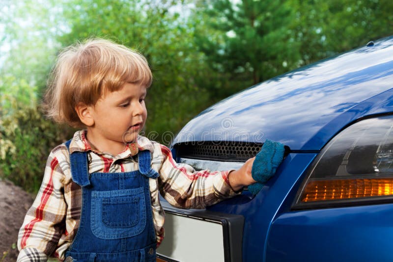Kid washing car with sponge stock image Kid washing car with sponge stock image