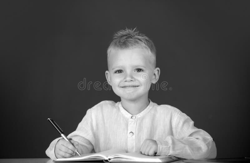 Kid writing in class. School child student learning in class, study english language at school. royalty free stock photo