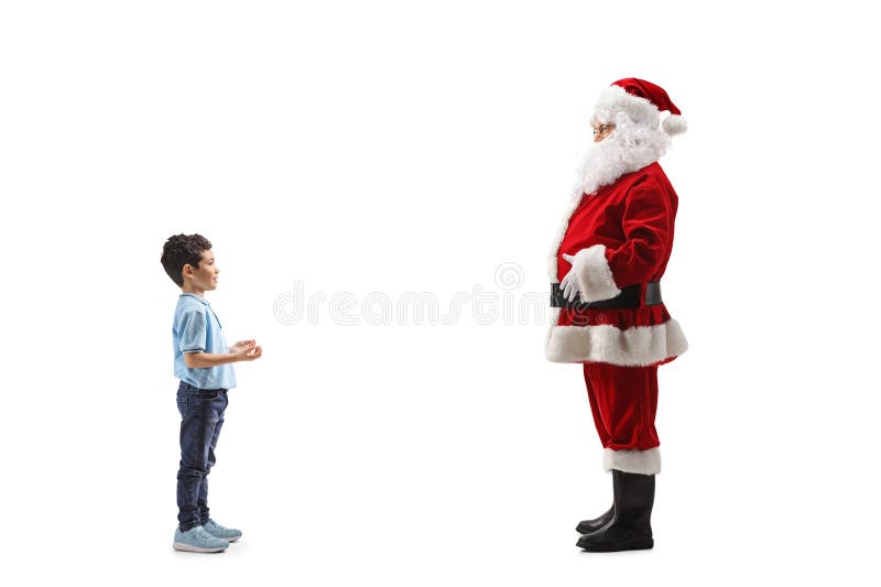 Kid în picioare și vorbesc cu Moș Crăciun royalty free stock images