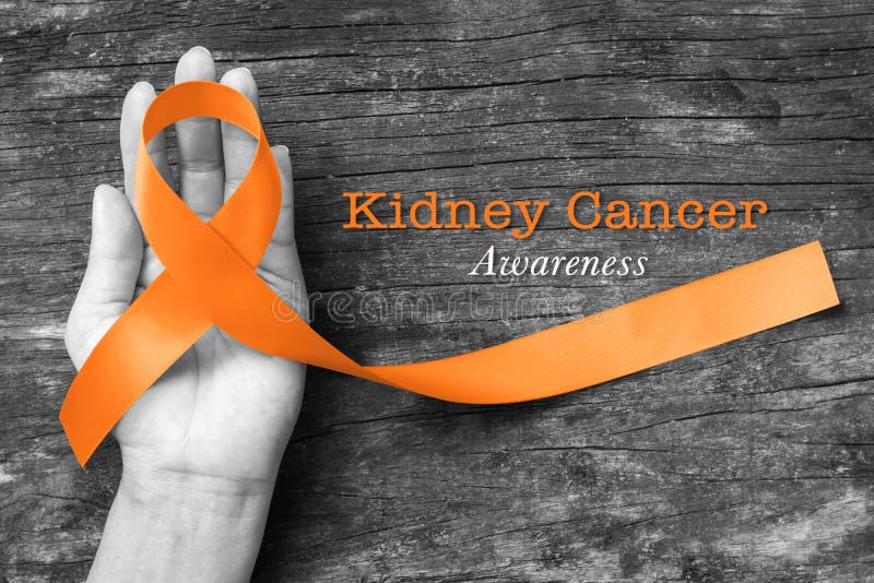 Kidney cancer awareness orange ribbon on human helping hand+ old aged background.