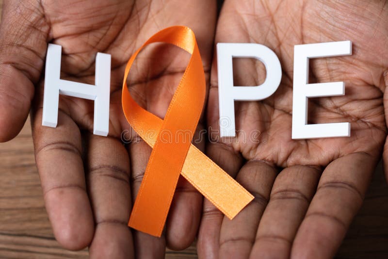 Kidney Cancer And Leukemia Awareness. Person`s Hand Holding Ribbon With Hope Text To Support Kidney Cancer And Leukemia Awareness