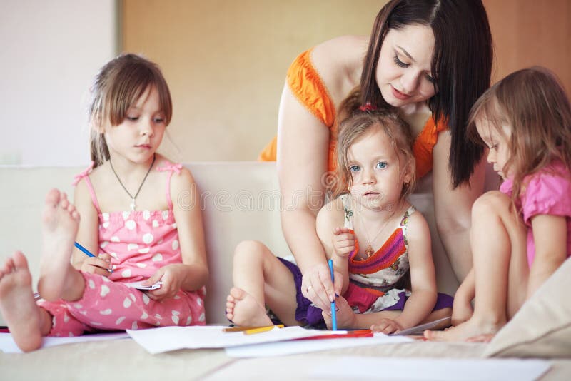 Group of kids playing together with their mother at home